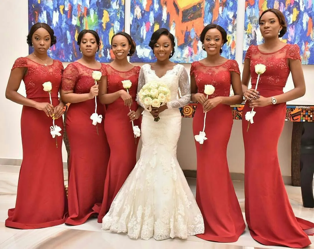 Bride and bridal train in red mermaid dresses