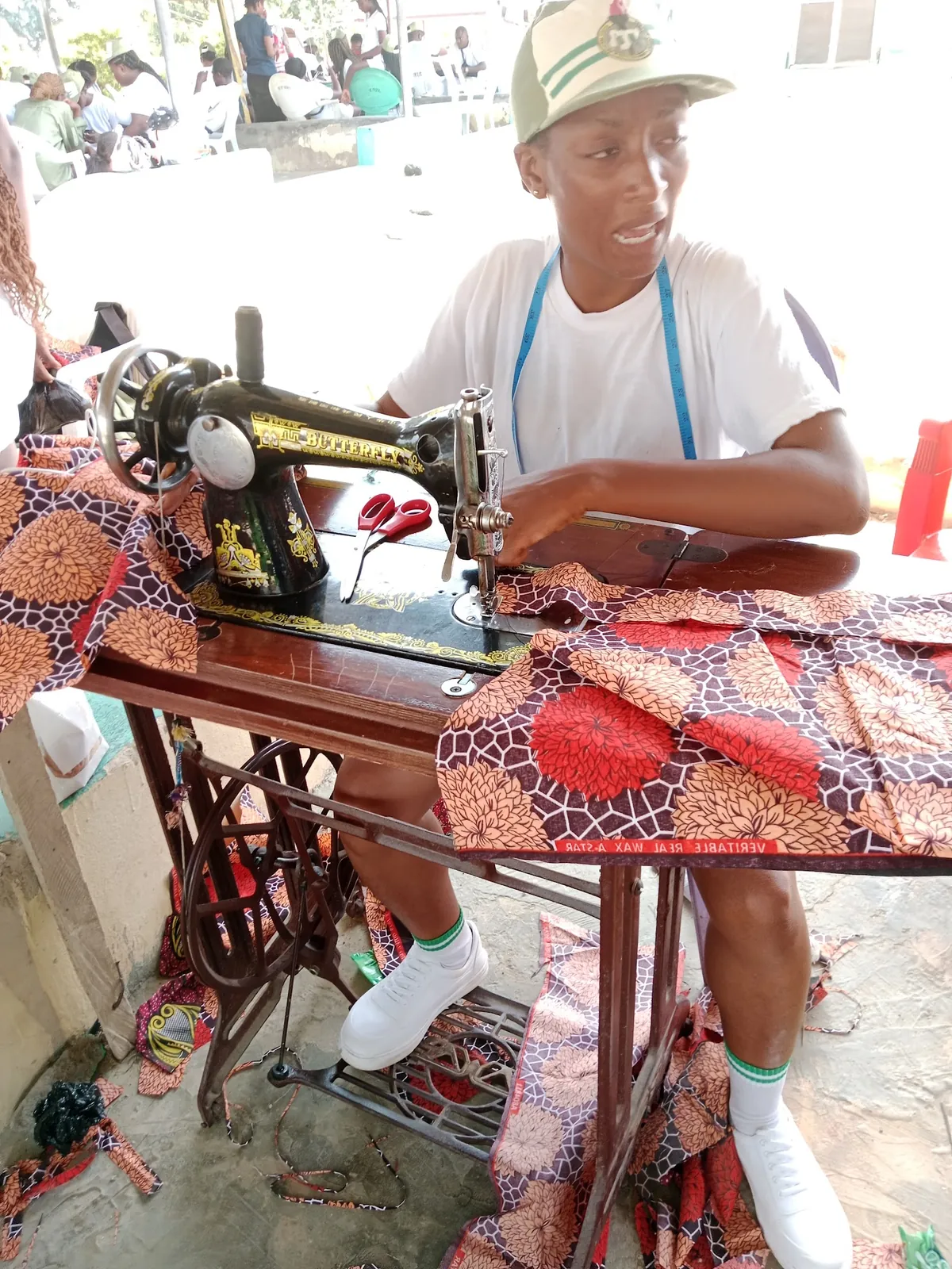 Trainee at a treadle sewing machine