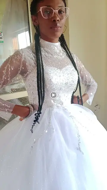 Bride wearing a long-sleeved Nikjade lace gown