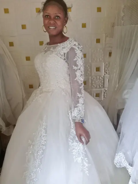 Long-sleeved lace ball gown on a mannequin